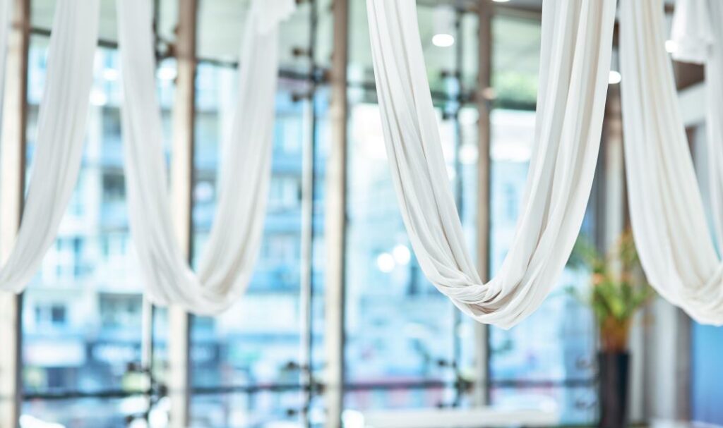 custom white curtains hanging from the ceiling