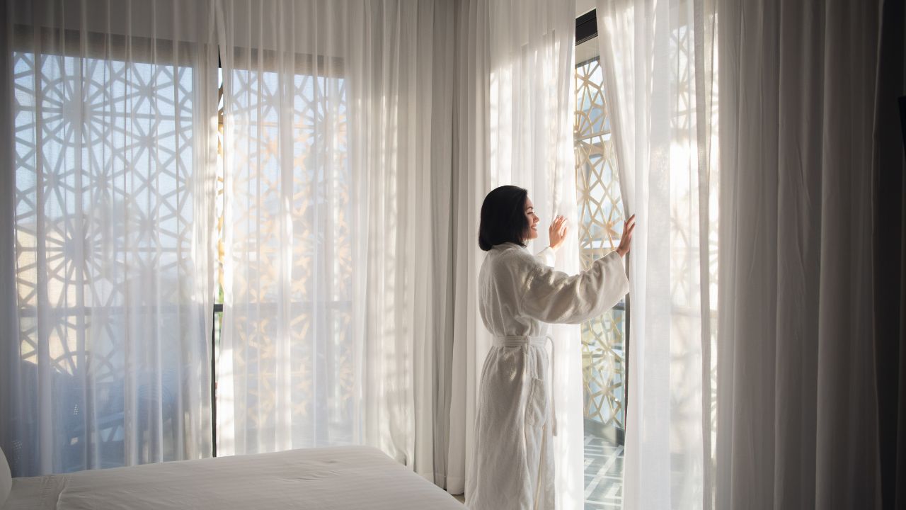 a woman and her window treatments